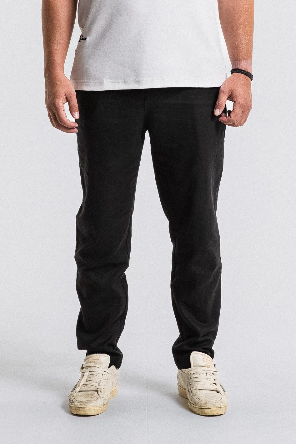 SEAM Tailored Lounge Linen Pant in Black, lower view showing straight-leg cut on shoe