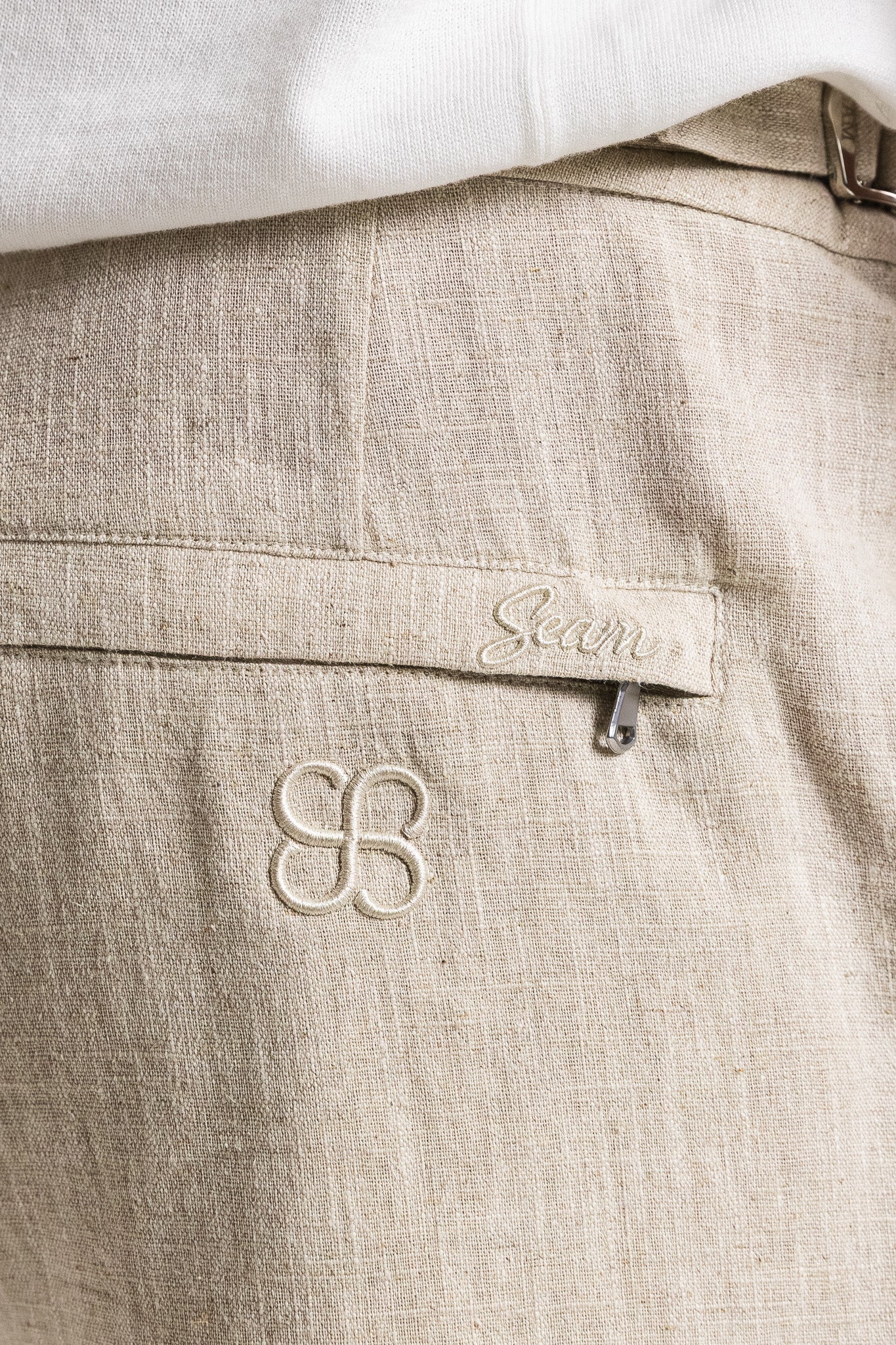 SEAM Side Tab Linen Short in Wheat, detail of pocket and embroidered Seam branding