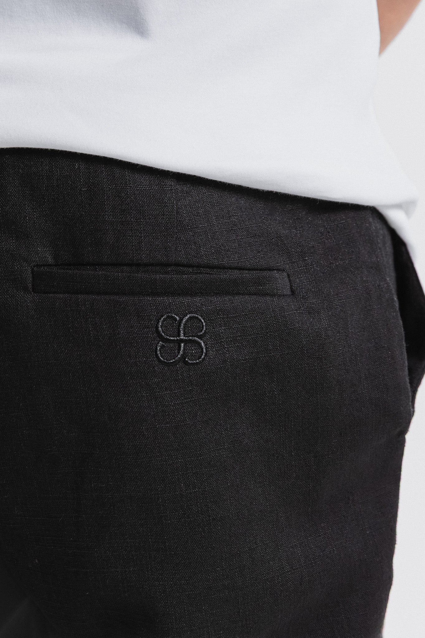 SEAM Tailored Lounge Linen Pant in Black, close-up of pocket and Seam embroidered logo