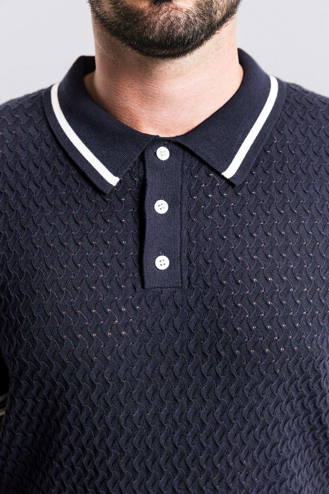 SEAM Textured Knit Cotton Polo in Navy, close-up of wave texture and contrast cuff stripe