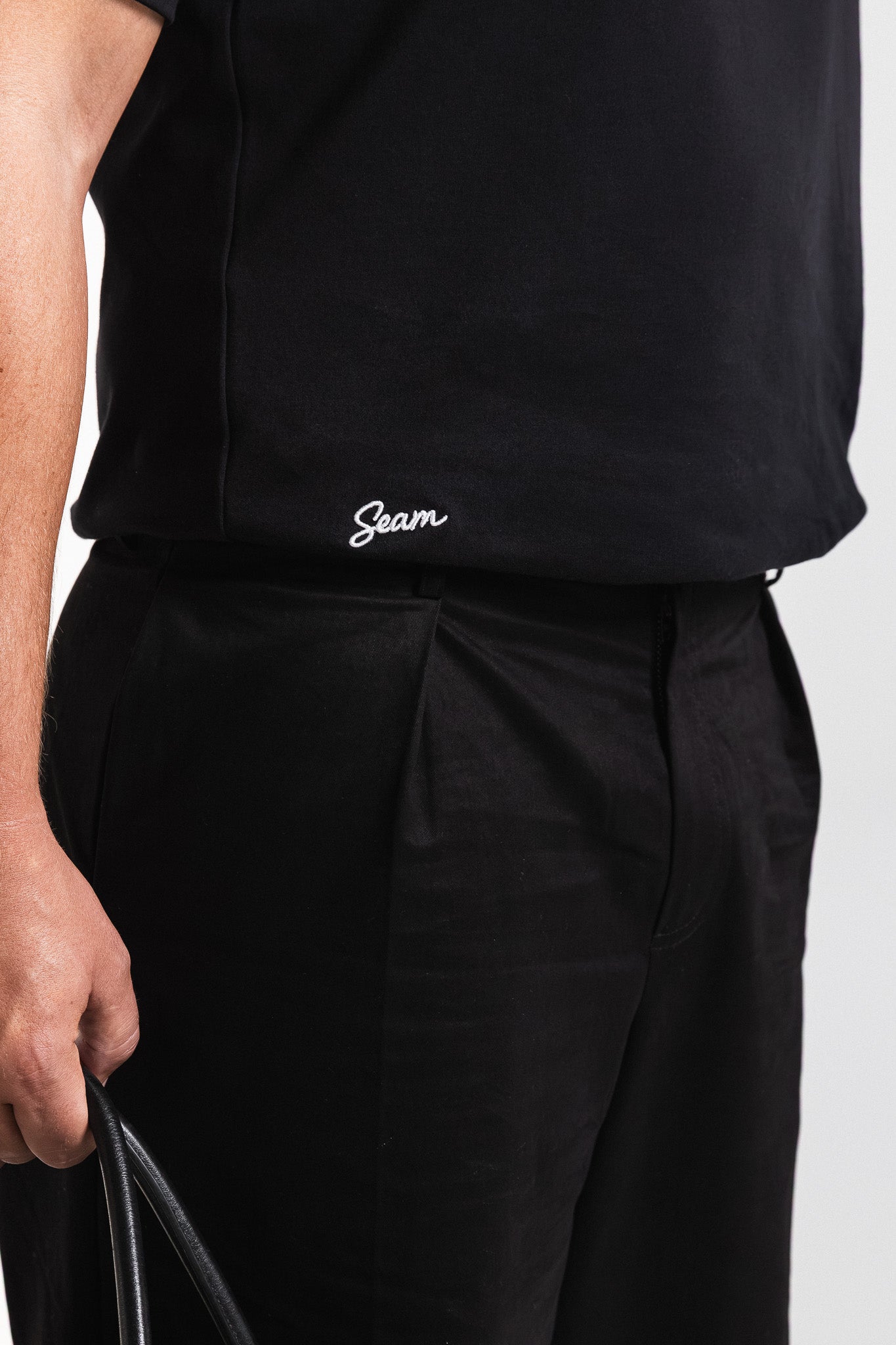 SEAM Relaxed Fit Cotton T-Shirt in Black, close-up of embroidered Seam logo