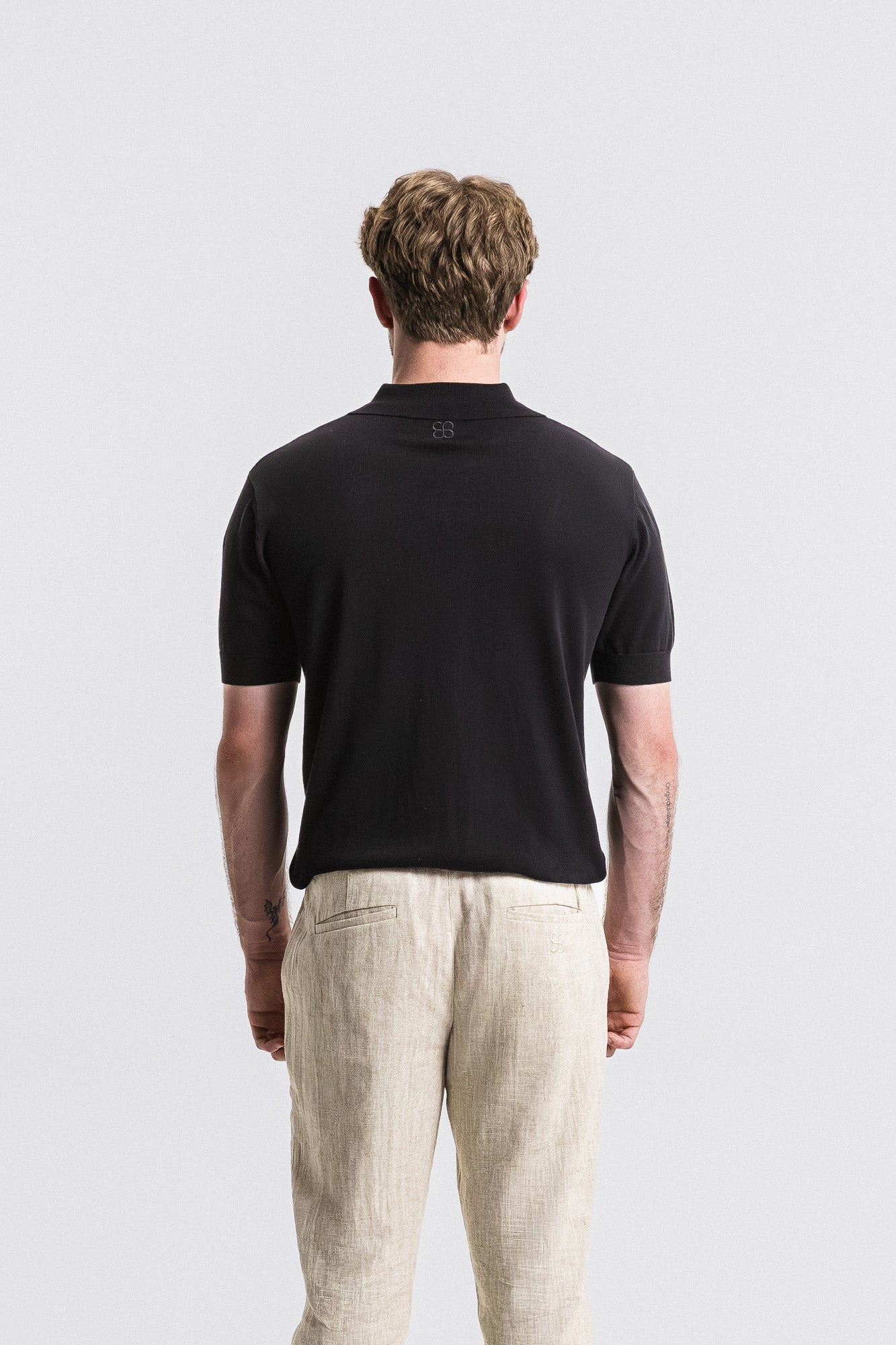 SEAM Cotton Knit Open Neck Polo in Black, front view showing relaxed open collar