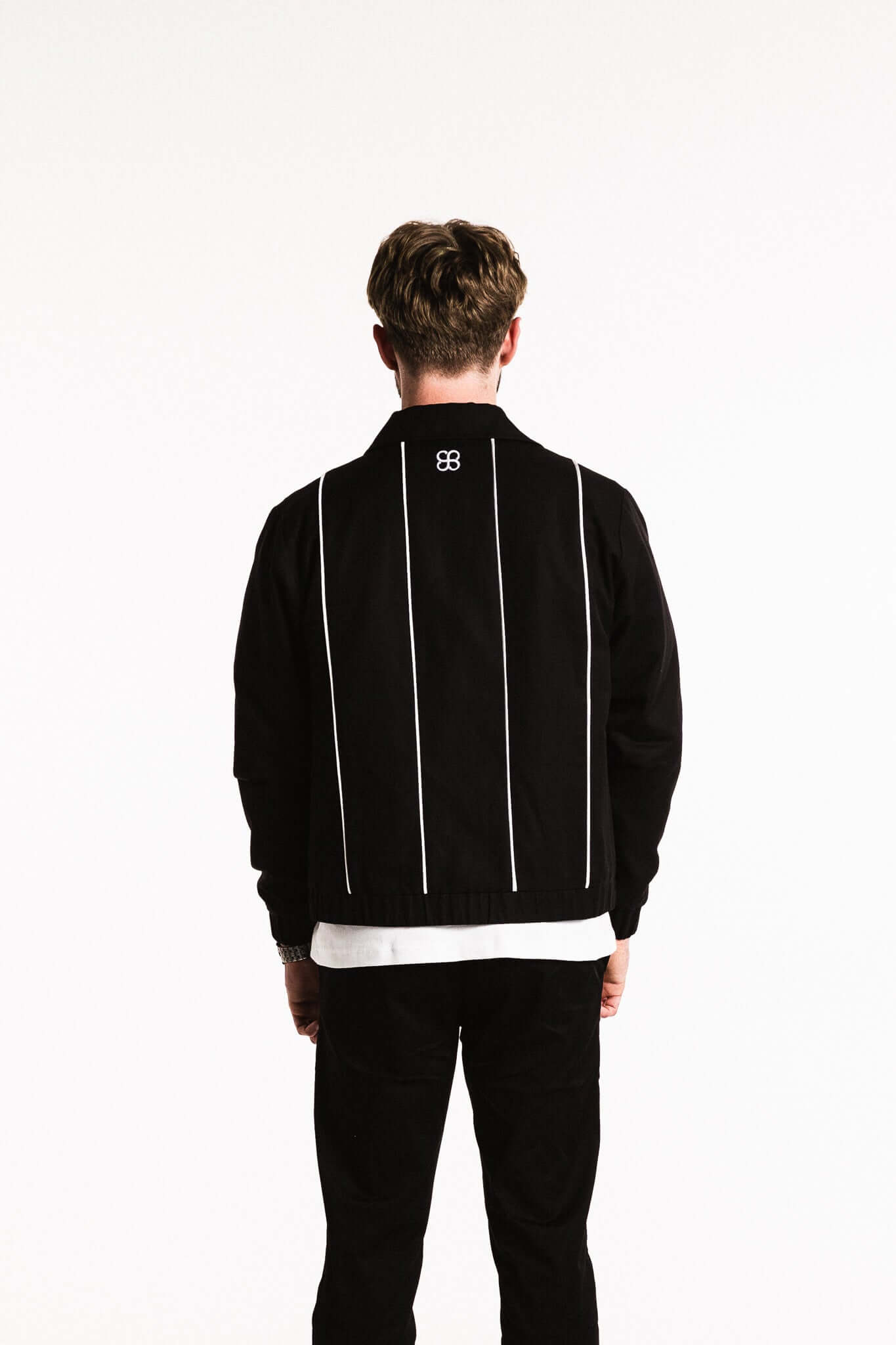 Cotton Contrast Jacket featuring contrasting white piping and SEAM embroidered branding, viewed from the back.