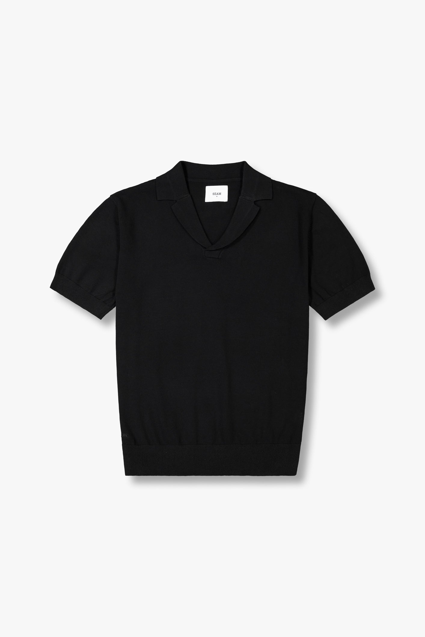 SEAM Cotton Knit Open Neck Polo in Black, flat lay showing open collar and jacquard cotton texture