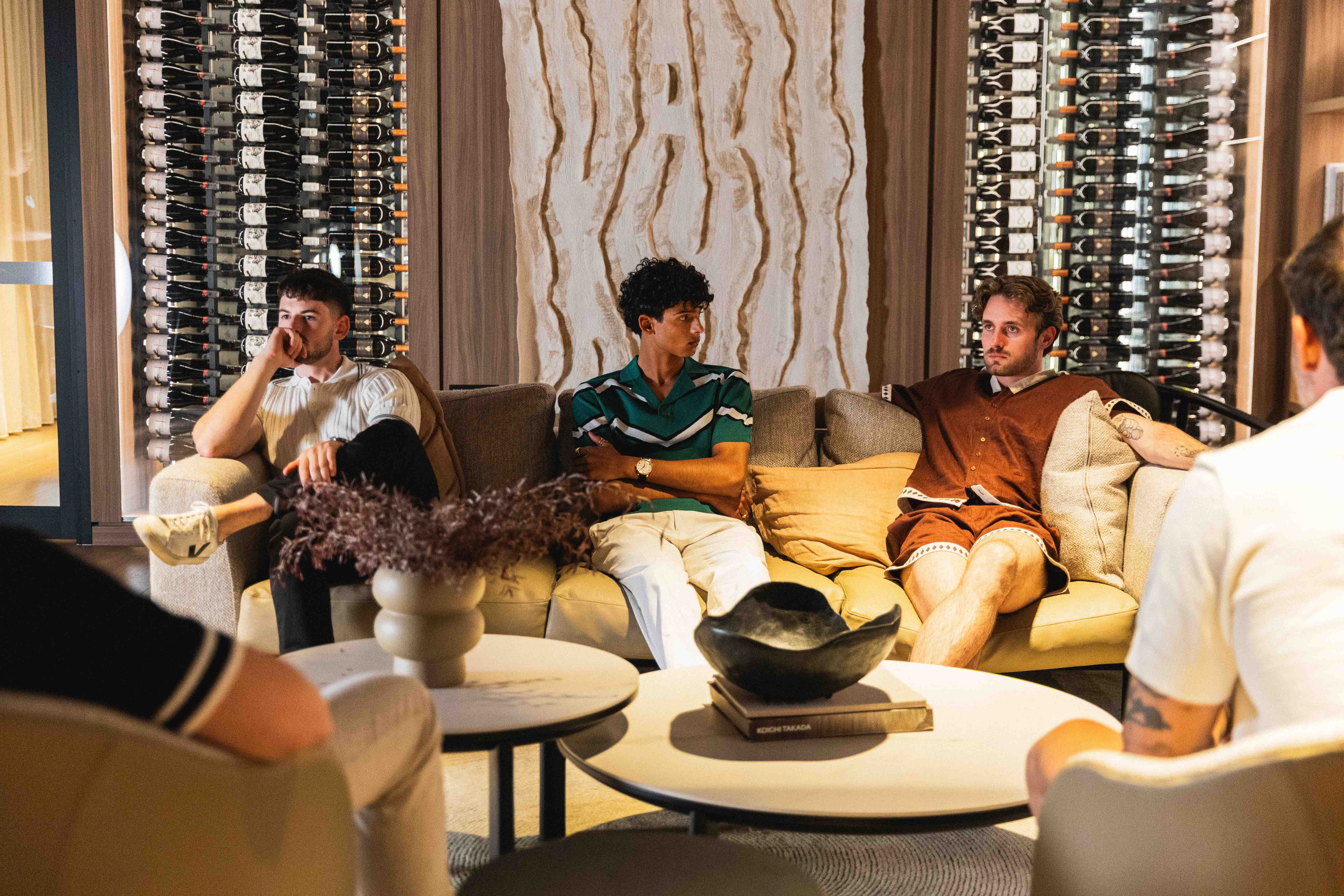 People sitting on a couch in a wine cellar