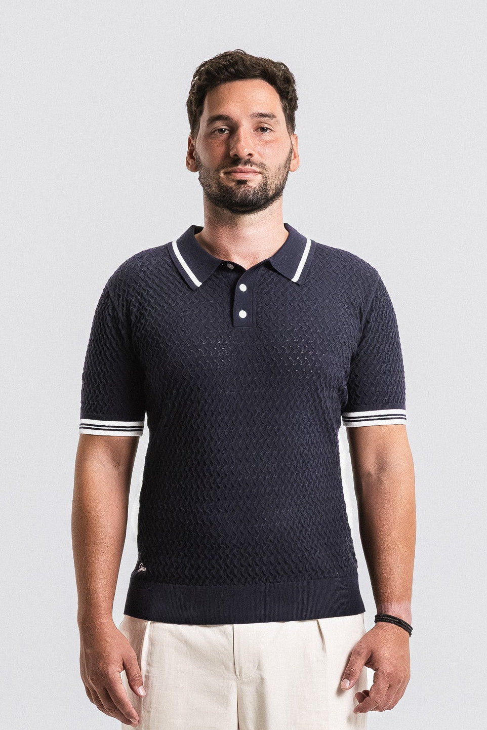 SEAM Textured Knit Cotton Polo in Navy, front view showing perforated knit and contrast trim