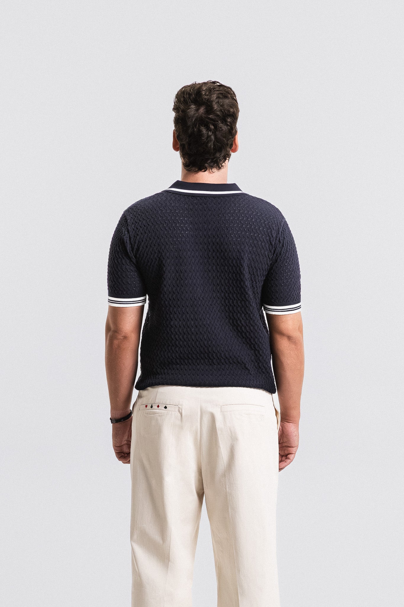 SEAM Textured Knit Cotton Polo in Navy, full outfit view with wheat trousers