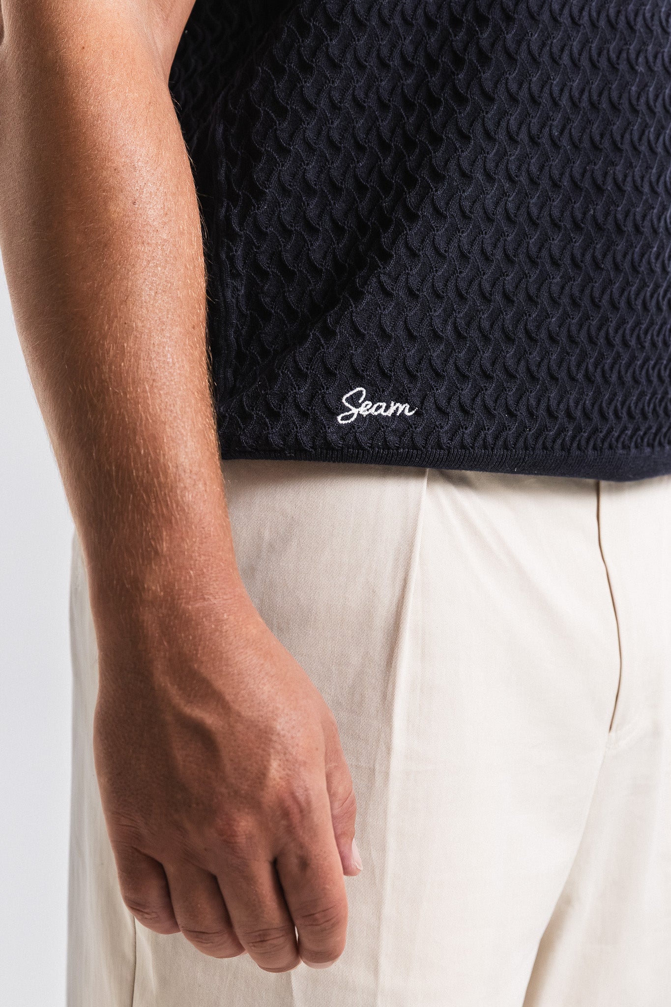 SEAM Textured Knit Cotton Polo in Navy, back view showing embroidered Seam branding