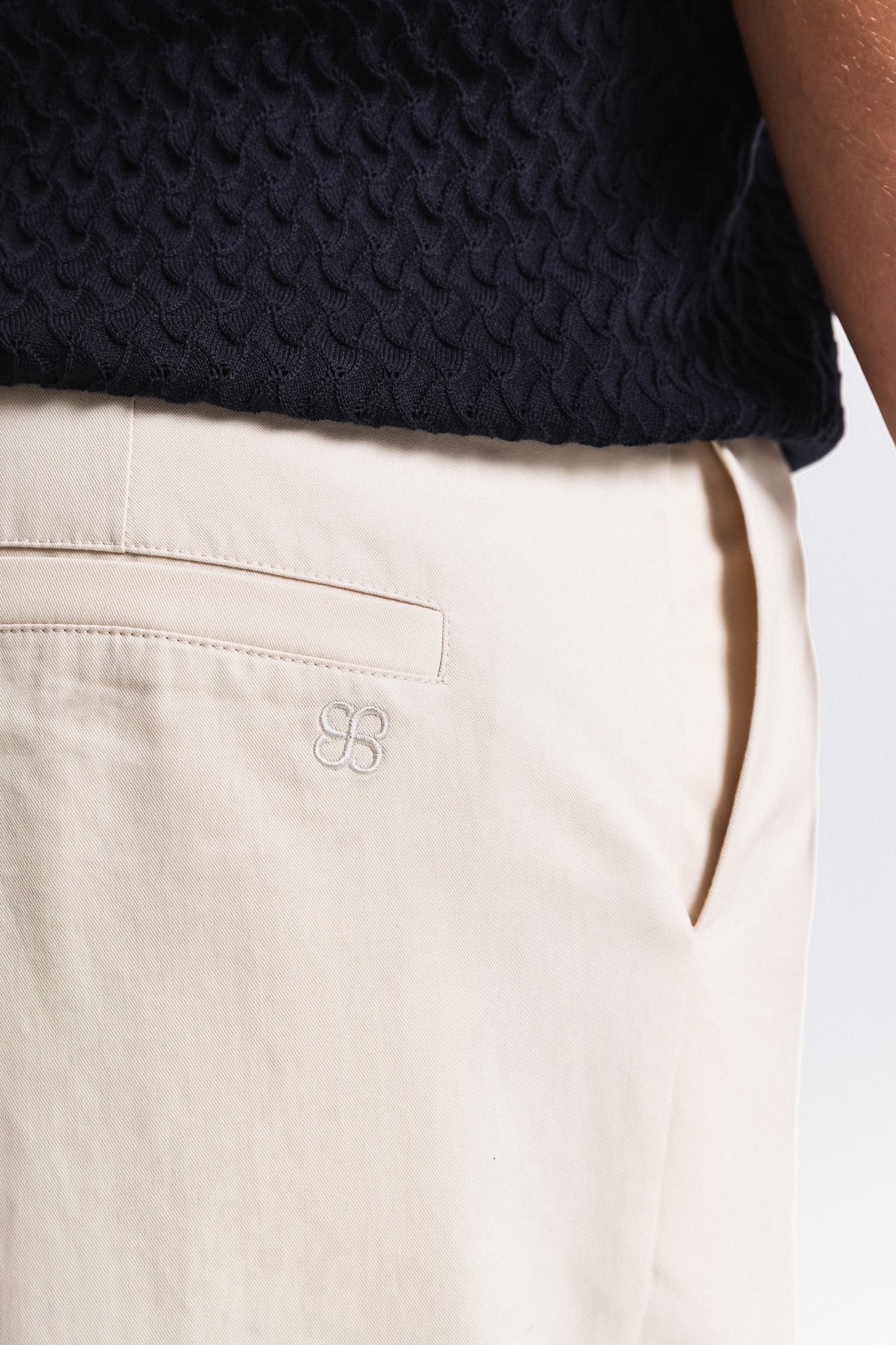 SEAM Poplin Pleated Trouser in Wheat, close-up of pocket detail and embroidered logo