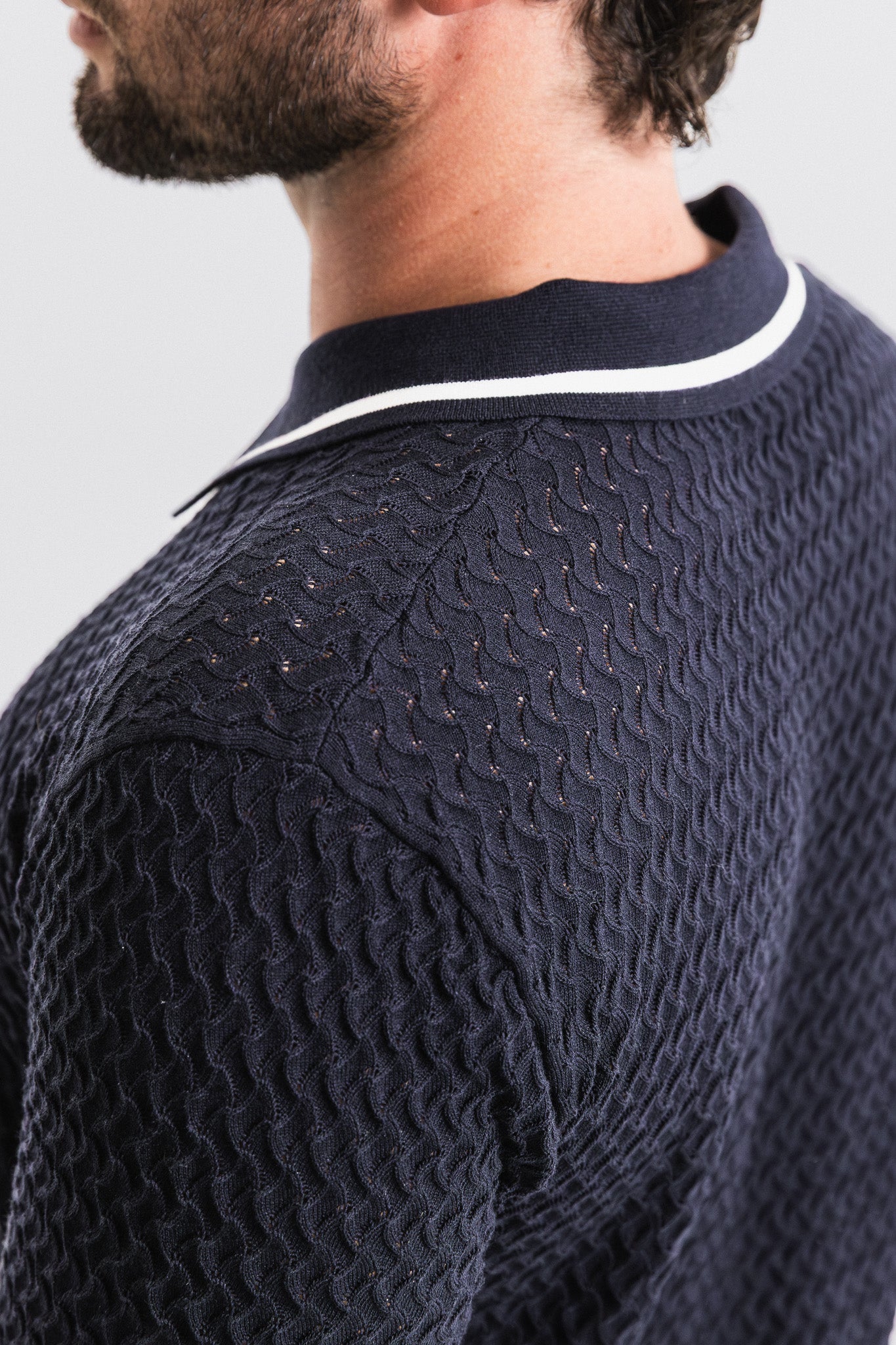 SEAM Textured Knit Cotton Polo in Navy, detail of perforated cotton knit pattern