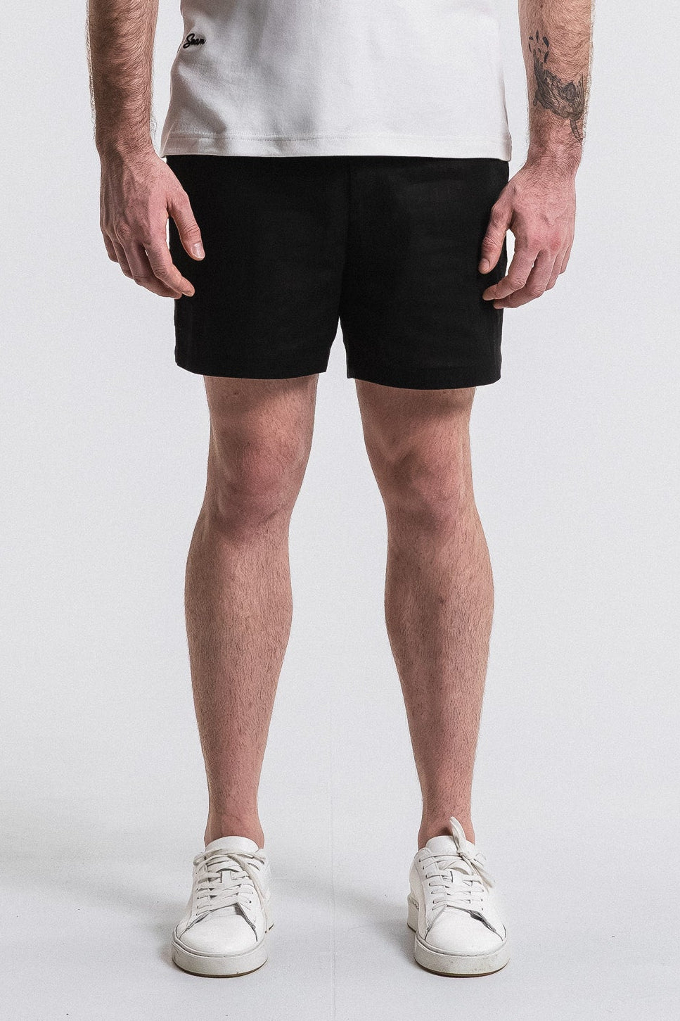 SEAM Side Tab Linen Short in Black, lower view showing mid-thigh linen drape