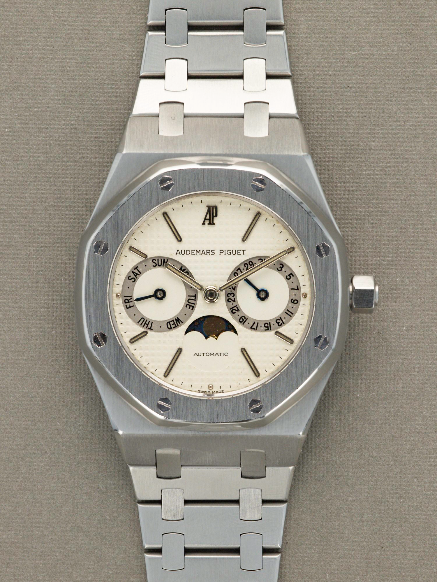 Silver Audemars Piguet watch on a gray background