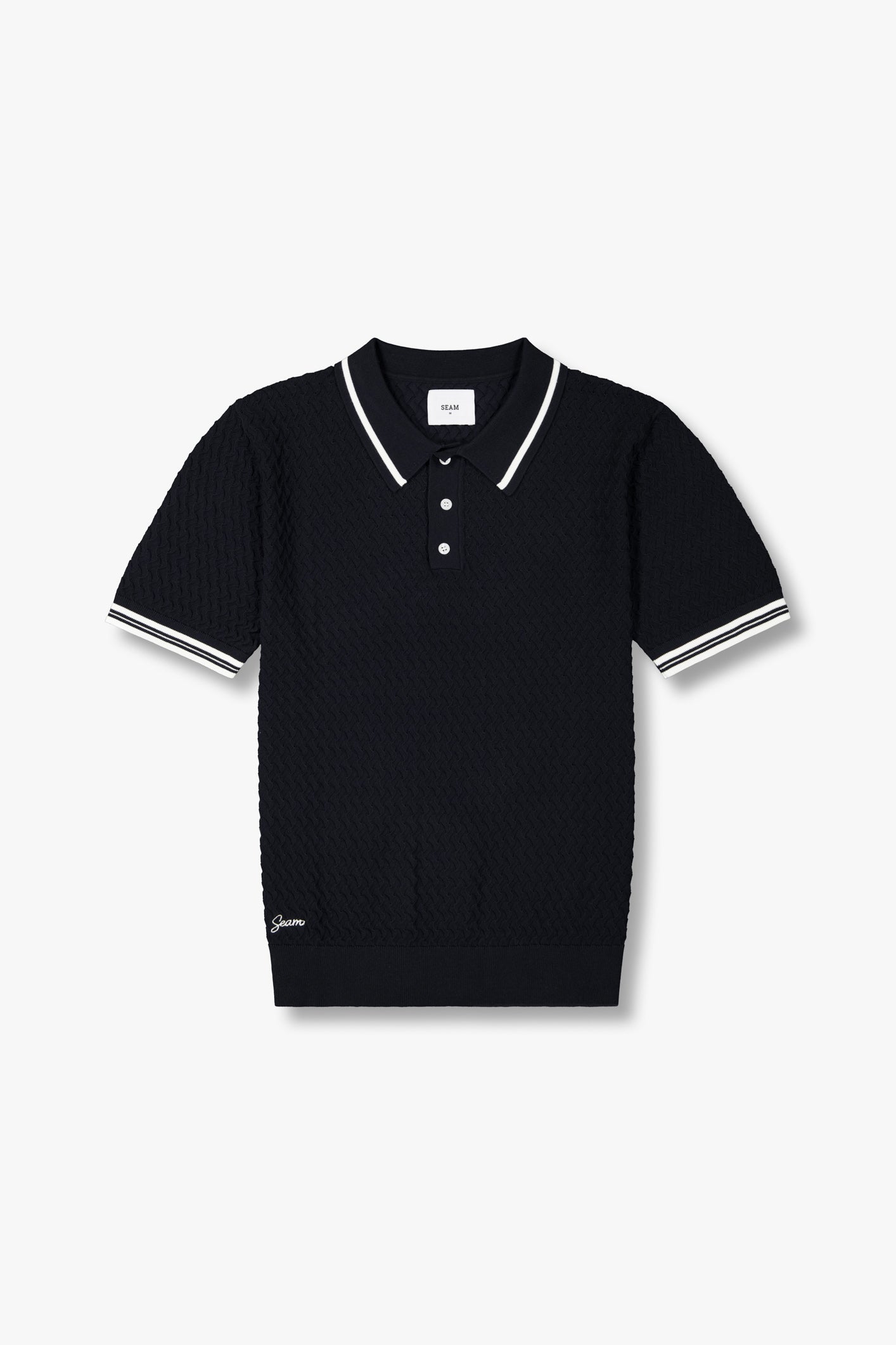 SEAM Textured Knit Cotton Polo in Navy, flat lay showing perforated knit texture and contrast stripe
