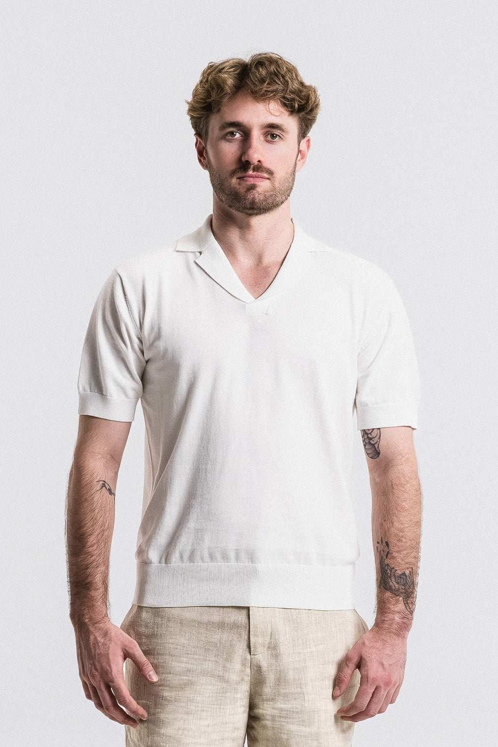 SEAM Cotton Knit Open Neck Polo in White, full outfit view with beige shorts