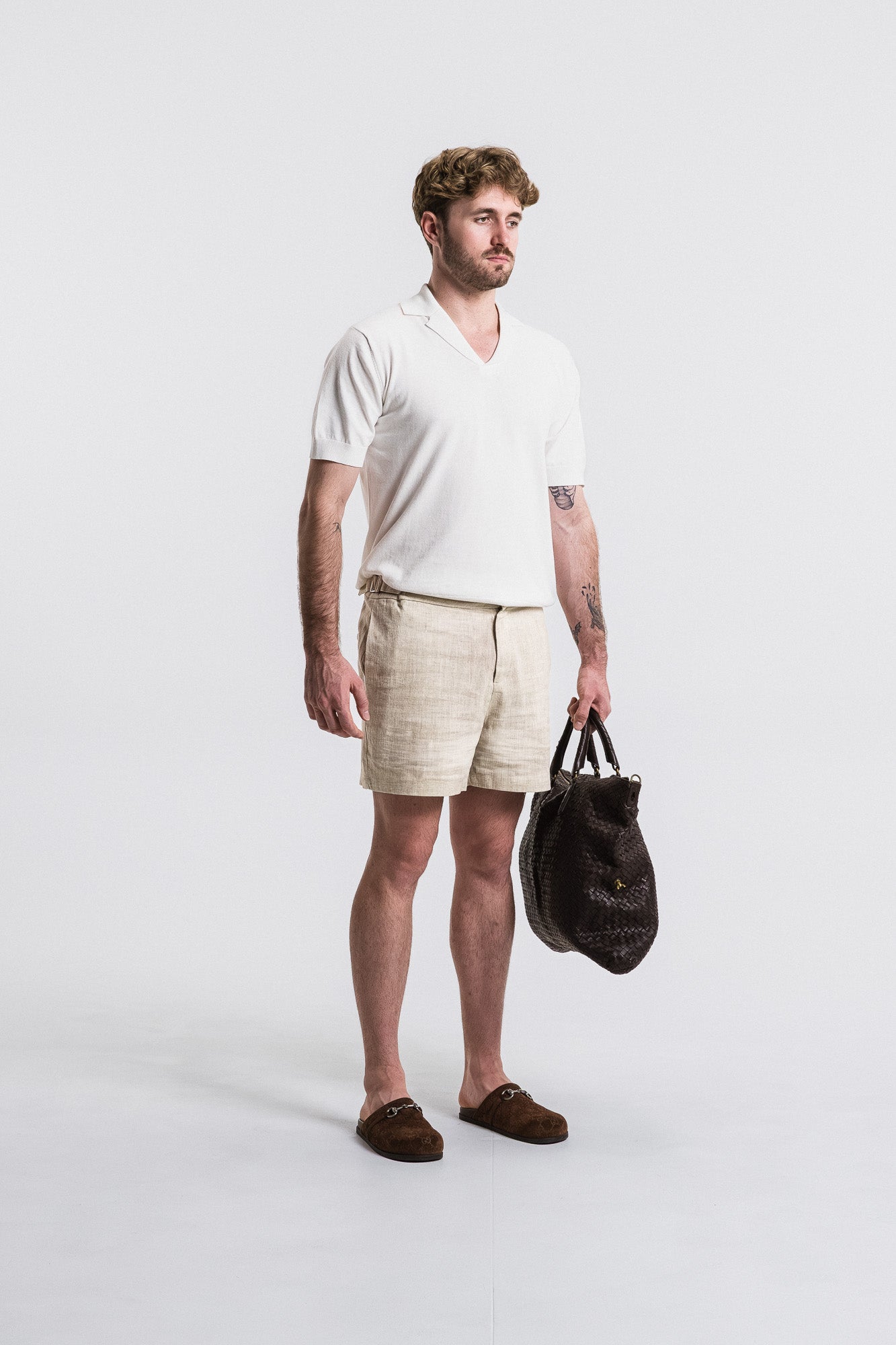 SEAM Cotton Knit Open Neck Polo in White, model styled with linen shorts and bag